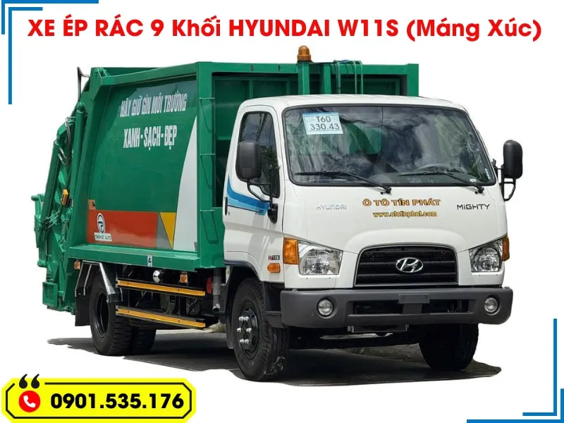 Xe Ép Rác 9 Khối Hyundai - Euro 5 (Máng Xúc) 18 Toàn cảnh xe ép rác 9 khối Hyundai W11S màu xanh lá cây, chụp từ góc chéo phía trước, làm nổi bật cả phần cabin lẫn thùng xe.